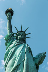 Fototapeta na wymiar New York City / USA - AUG 22 2018: The statue of liberty back view in clear blue sky
