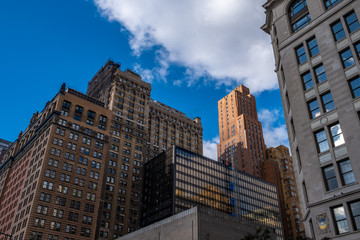 Fototapeta na wymiar New York City / USA - OCT 24 2018: Residence building in lower Manhattan against clear blue sky