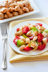 Salad with three kinds of tomatoes, boiled white kidney beans and croutons from white bread