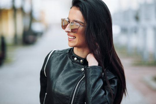 Autumn portraits of a beautiful girl in a black leather jacket
