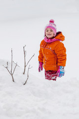 Baby girl playing in the snow