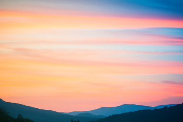 Fototapeta na wymiar Fire Sunset at mountains. Sky and clouds texture