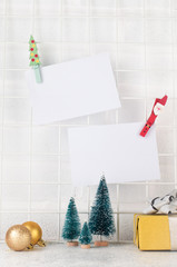 Christmas mood board with empty cards on it near Christmas decor