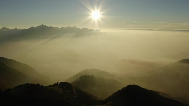Flying high above mist layer at sunset in alpine environment. Near "Les Rochers de Naye", Switzerland