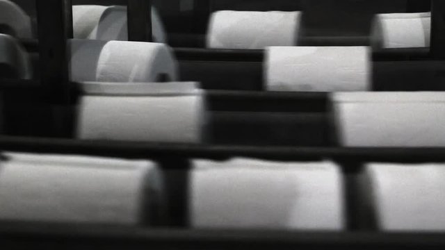 Paper plant, paper tissue rolls on conveyor line. Closeup.