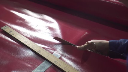 men's hands cut with scissors plastic awning close up