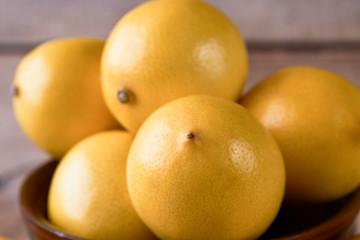 Fresh Juicy Lemon cut on wooden table, close-up. 