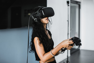 South-East asian girl playing VR game