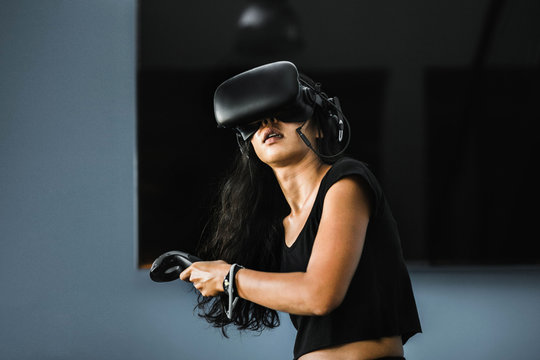 South-East asian girl playing VR game