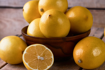 Fresh Juicy Lemon cut on wooden table, close-up. 
