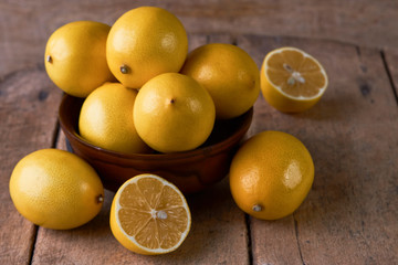 Fresh Juicy Lemon cut on wooden table, close-up. 