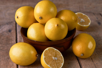 Fresh Juicy Lemon cut on wooden table, close-up. 