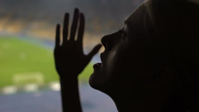 Portrait of emotional lady cheering while watching sports match on stadium