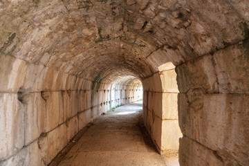Ruins of the ancient Theatre at Miletus in the Aydin Province of Turkey.  View through the arches beneath seating area.