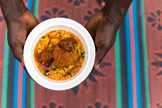 Person holding bowl of food