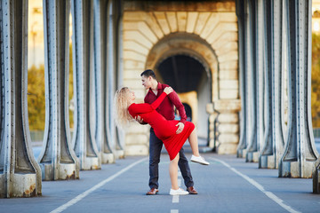 Romantic couple kissing on Bir-Hakeim bridge in Paris, France