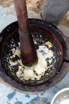 A motar and pestle being used to make a meal
