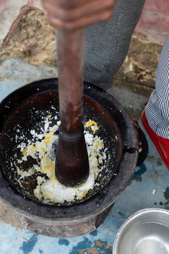 Person using a mortar and pestle