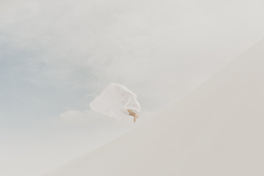 White on white concept with a white flow fabric hiding a human silhouette