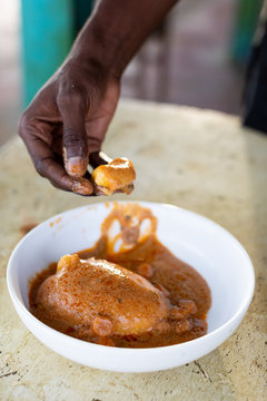 Person holding a piece of a fufu