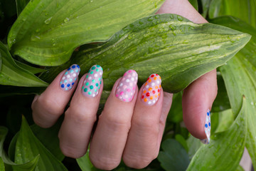nail art manicure with colorful polish nails and flowers. Beauty hands and stylish nails.
