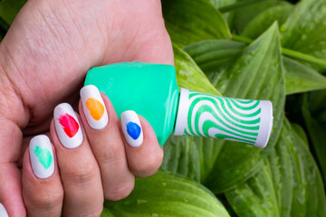 nail art manicure with colorful polish nails and flowers. Beauty hands and stylish nails.
