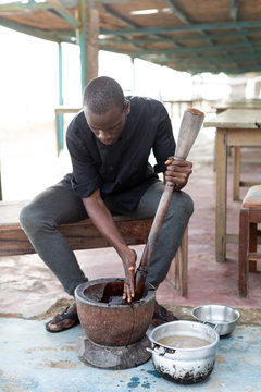 Man using a mortar and pestle
