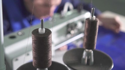 close-up of the thread coil on the sewing machine while working