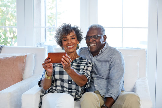 African American senior couple having a video chat with family with a camera phone