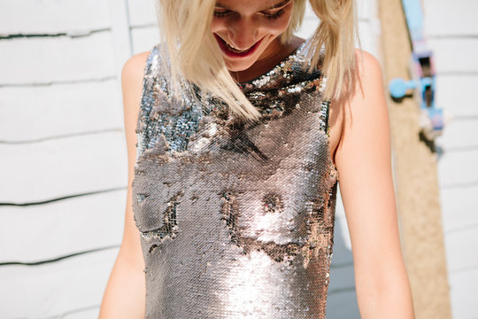 Woman in a sequin dress with breasts drawn on it