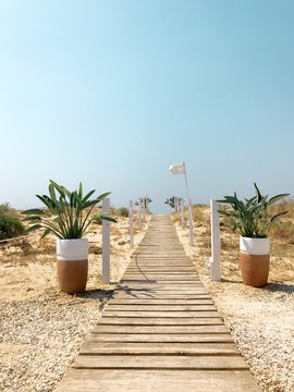 View towards the sea along a boardwalk from a lido, Puglia
