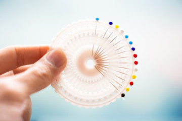 Hand holding colorful pins