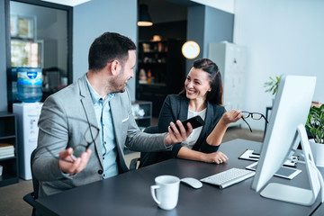 Business people having fun and chatting while working in the modern office.