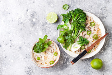 Vegetarian traditional Vietnamese soup Pho bo with herbs, rice noodles, broccolini, bok choy, bean sprouts, mushrooms. Vietnam national dish. Asian food concept.