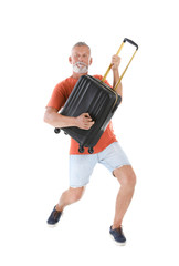 Senior man with suitcase on white background. Vacation travel