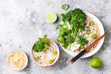 Vegetarian traditional Vietnamese soup Pho bo with herbs, rice noodles, broccolini, bok choy, bean sprouts, mushrooms. Vietnam national dish. Asian food concept.
