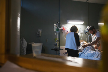 Mother and partner supporting woman in childbirth