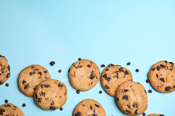 Delicious chocolate chip cookies on color background, flat lay. Space for text