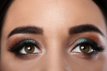 Young woman with eyelash extensions and beautiful makeup, closeup view