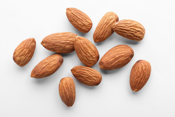 Organic almond nuts on white background, top view. Healthy snack