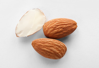Organic almond nuts on white background, top view. Healthy snack
