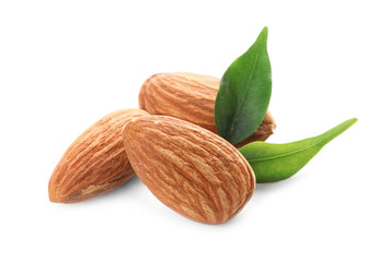 Organic almond nuts and leaves on white background. Healthy snack