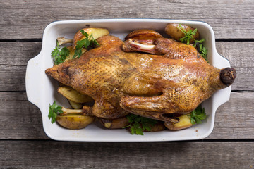 Homemade baked duck with potatoes and apple . Christmas food