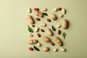Composition with peanuts on color background, top view
