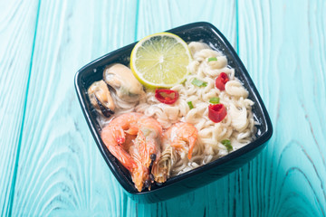 Instant noodles soup with shrimps and mssels . Asian food