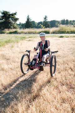 Disabled Active Woman Cycling in a Park