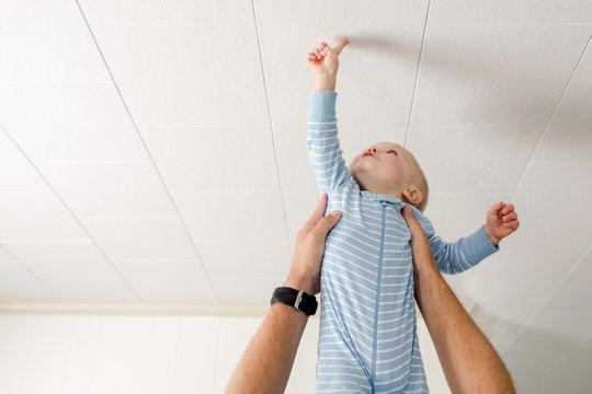 baby touching the ceiling