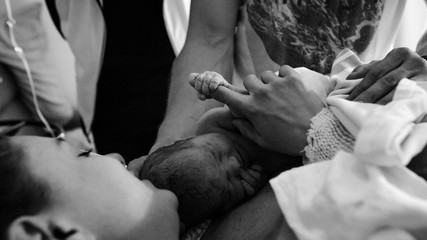 Brand new mother and child after delivery in hospital room