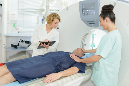 nurse adjusting patients face before mri scan