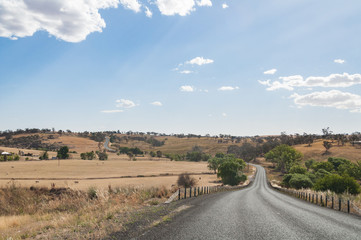 Fototapeta na wymiar Australian outback countryside road with farms on the side
